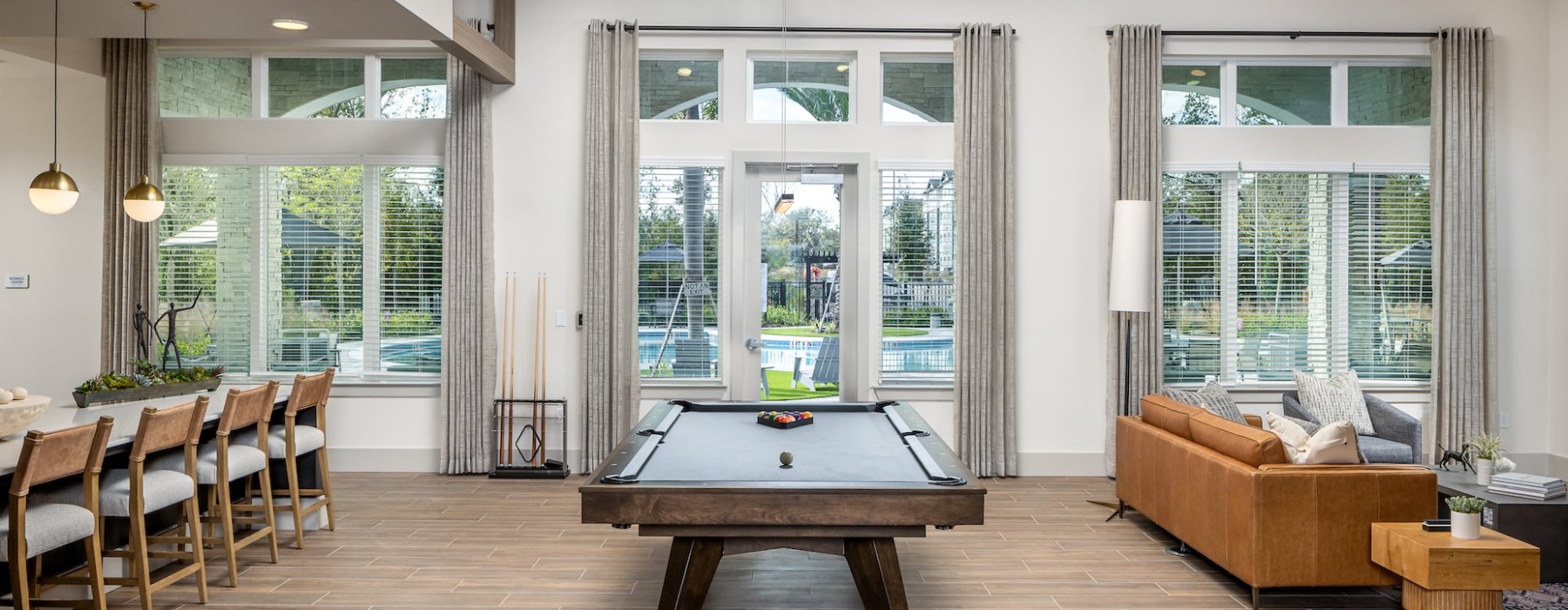 Well lit resident lounge with pool table and bar seating